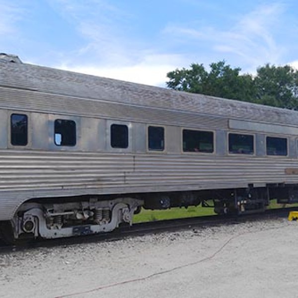 a train is parked on the side of the road