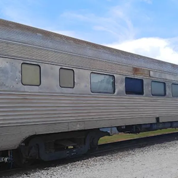 a passenger train that is parked on the side