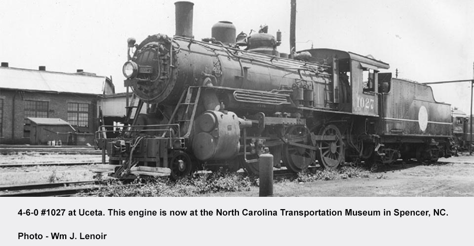 a steam engine is sitting on a train track