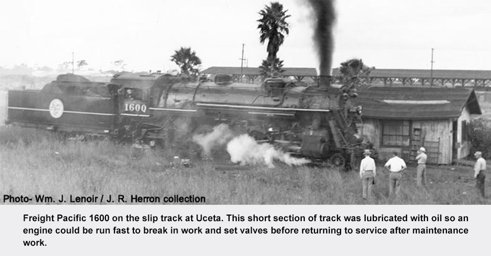 a train on a track with smoke coming out of it