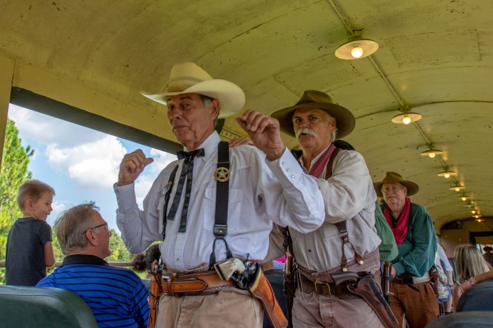 Train robbers holding the Marshal at gun point