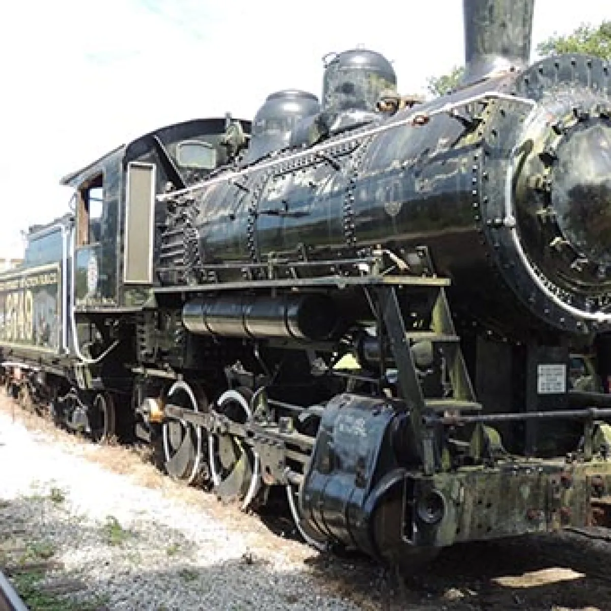 a steam engine is sitting on a train track