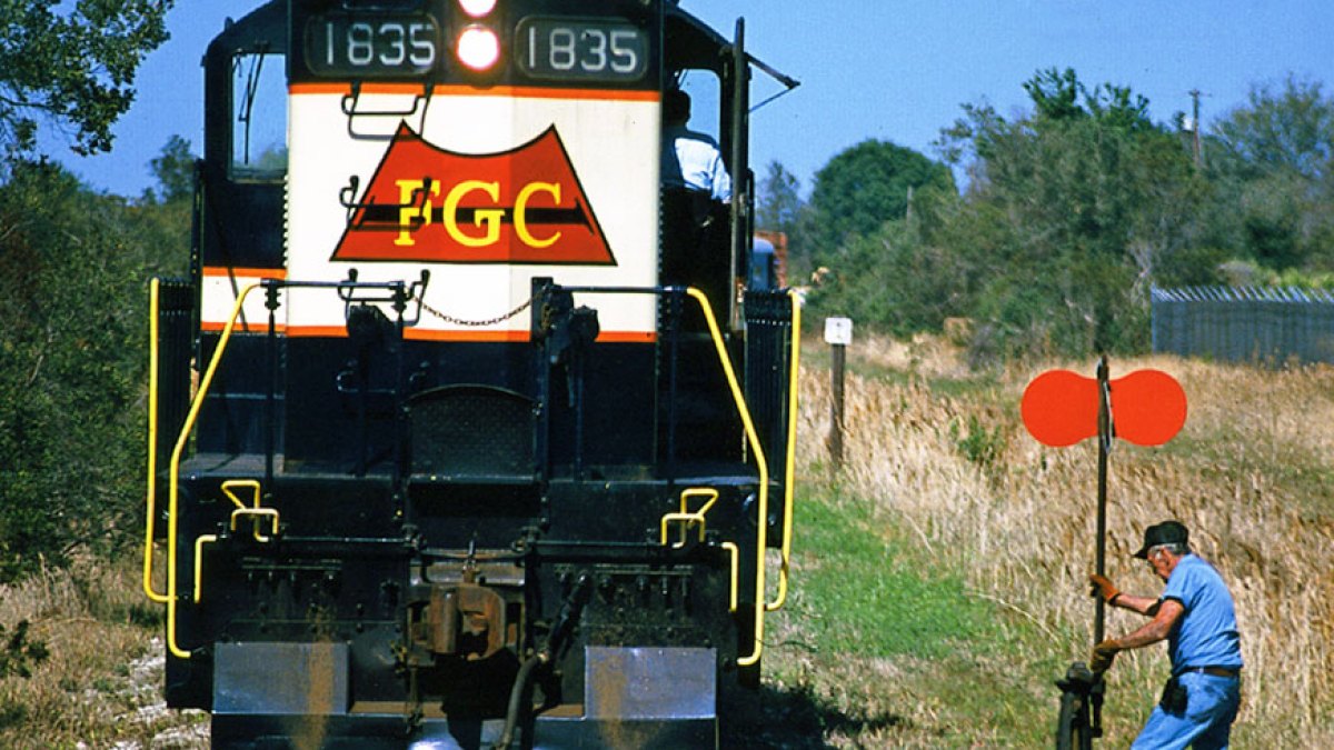 a man standing next to a train