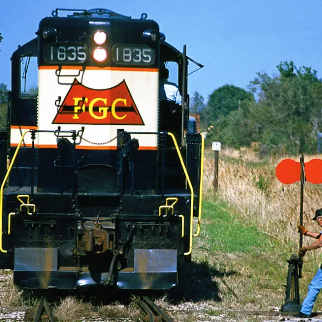 a man standing next to a train