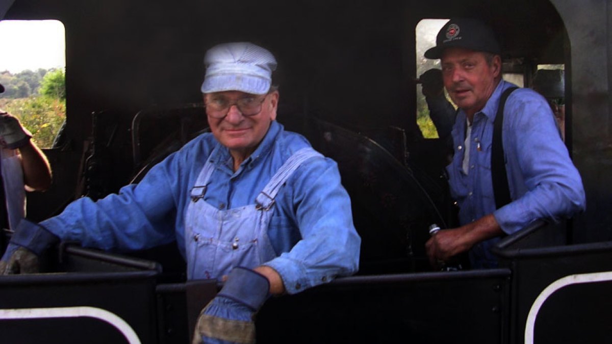 a group of people looking at a laptop