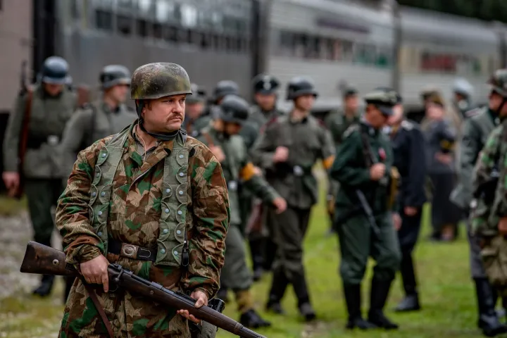German soldiers in uniform by a train