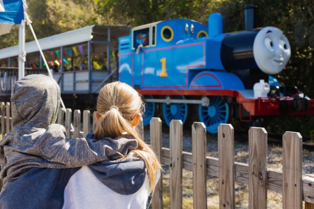 a person standing in front of a stuffed animal